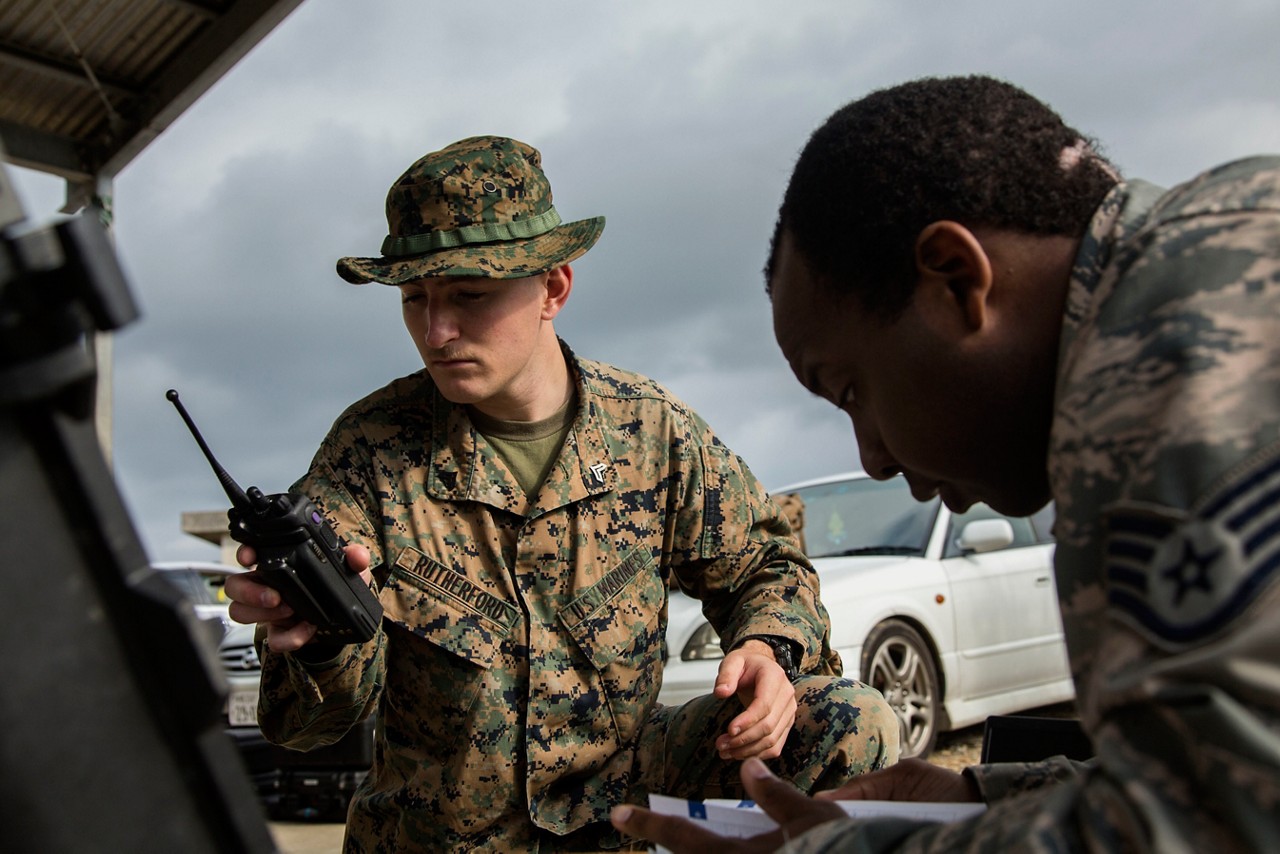 Marines performing a radio check during a simulated CBRN response drill.