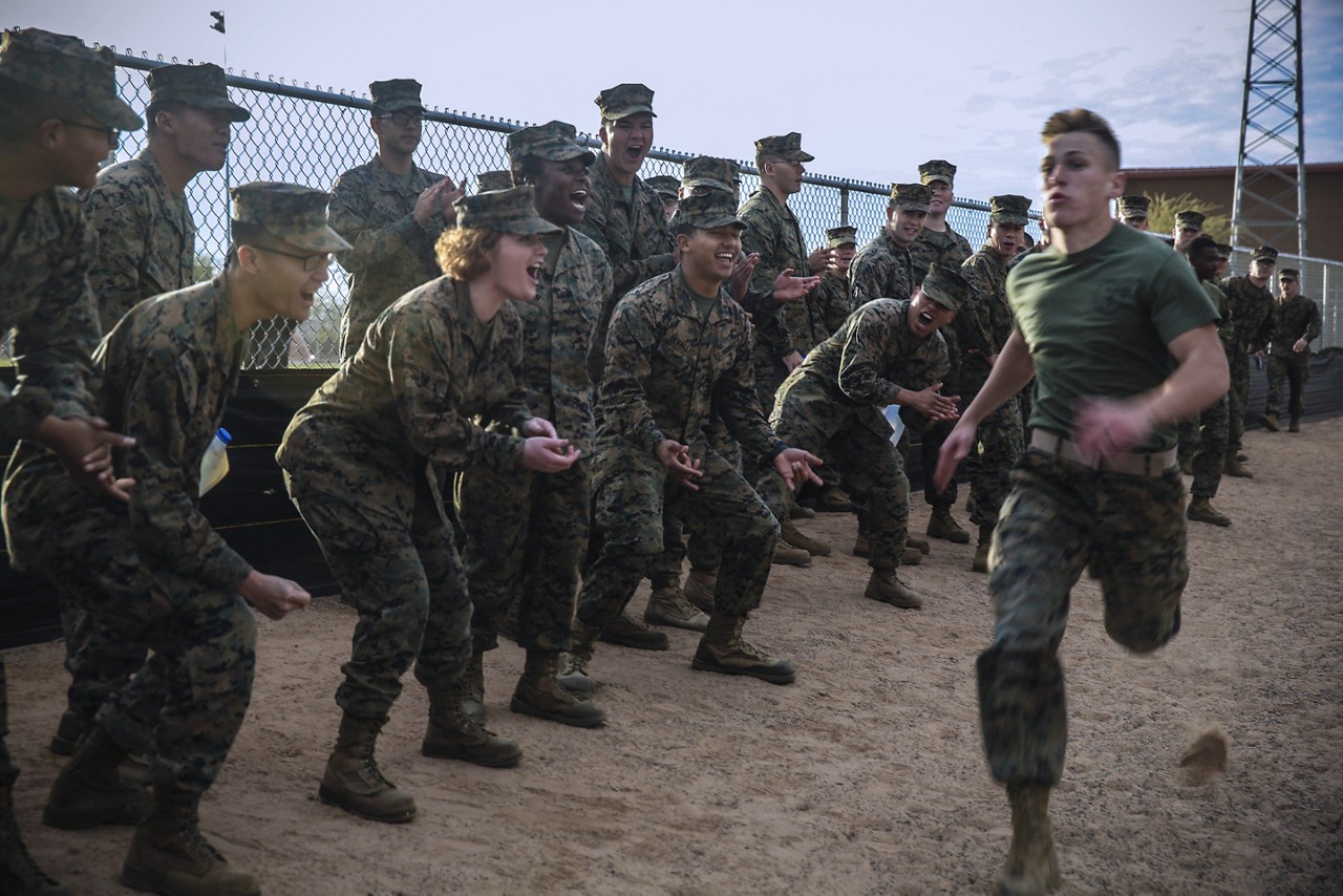 Marines encouraging each other during a competition set up by the Marine and Morale, Welfare, and Recreation (MWR) specialist.