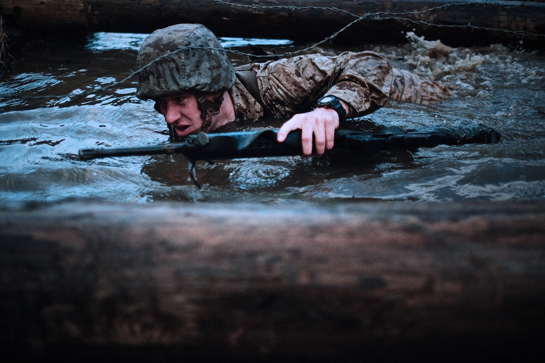 Marine training in the water with a rifle