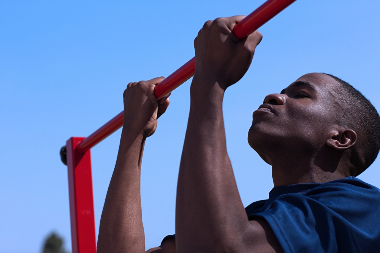 Marine recruit doing pull ups during delayed entry program training.