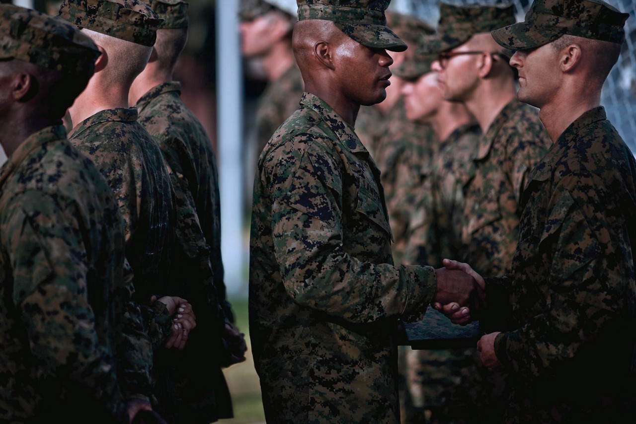 Marines receiving emblems after completing recruit training.