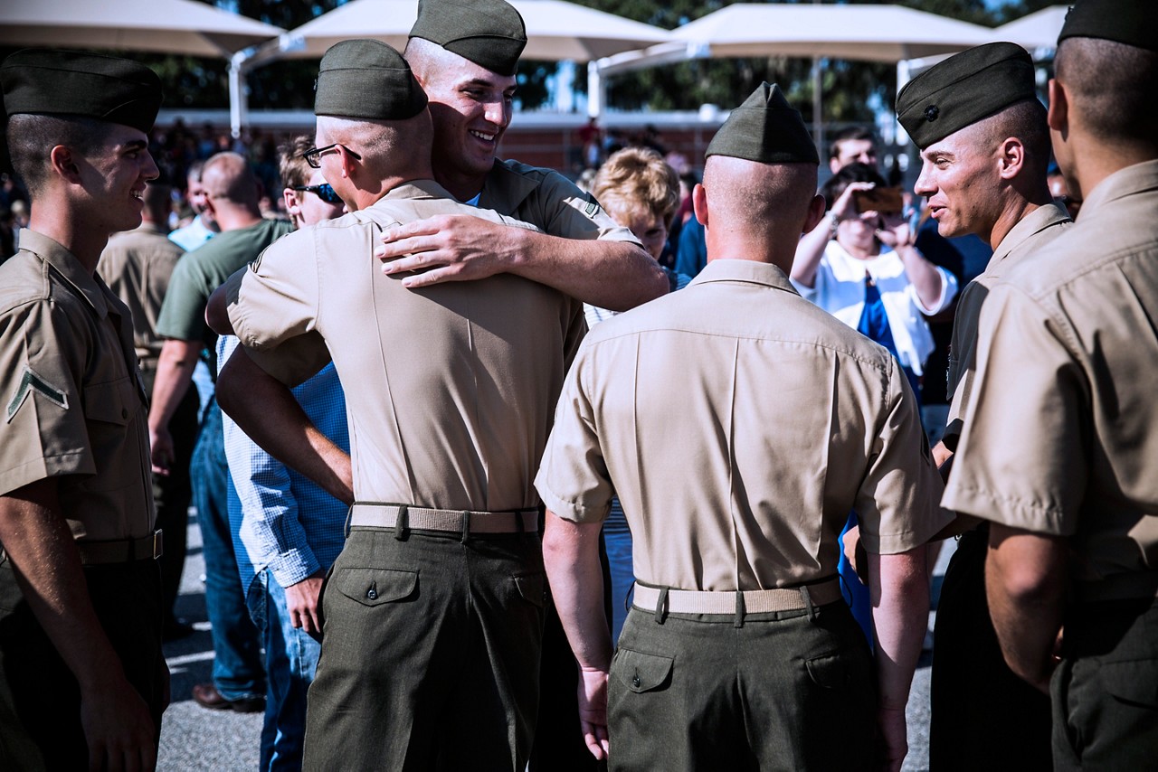 Marines congratulating each other after graduation from recruit training.