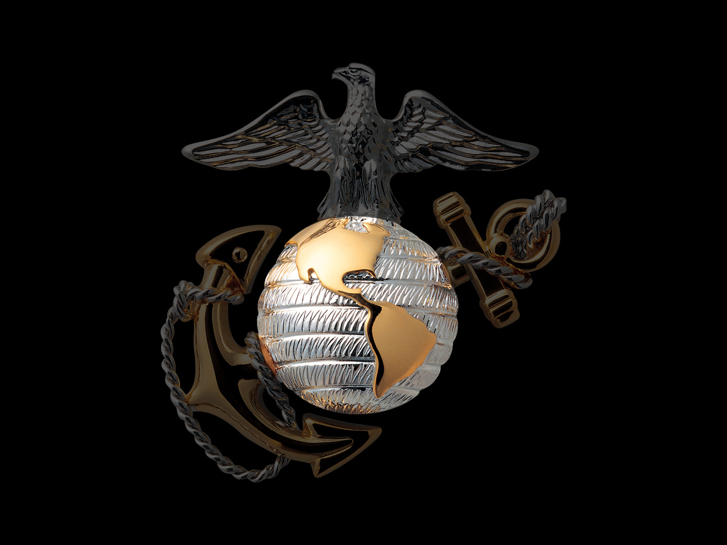 Marine Corps Eagle Globe and Anchor emblem with illuminated gold globe against dark background.