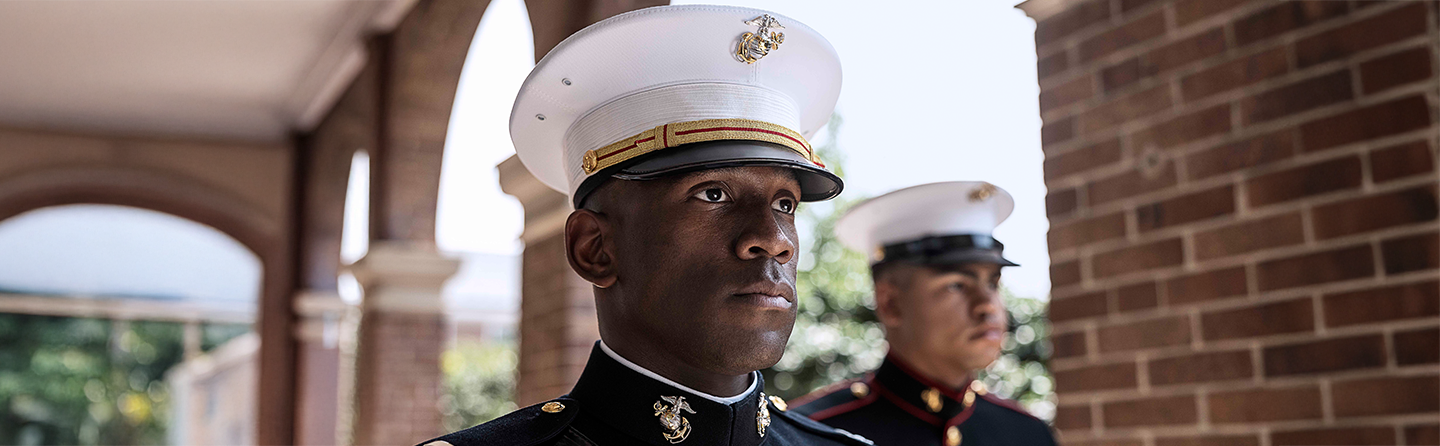 Marines in dress blue uniforms displaying the professional standards and structure of Marine Corps ranks.