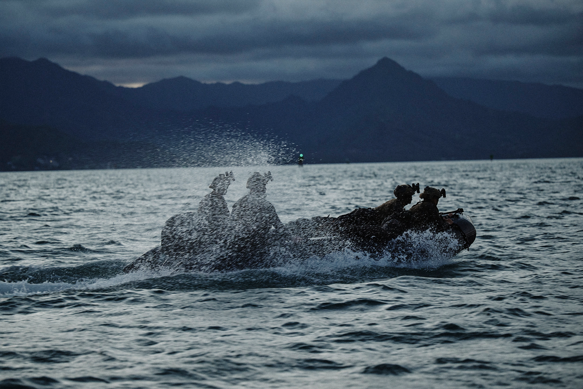 Marines conducting amphibious assault training in combat boat, demonstrating sea-to-shore operations capability.