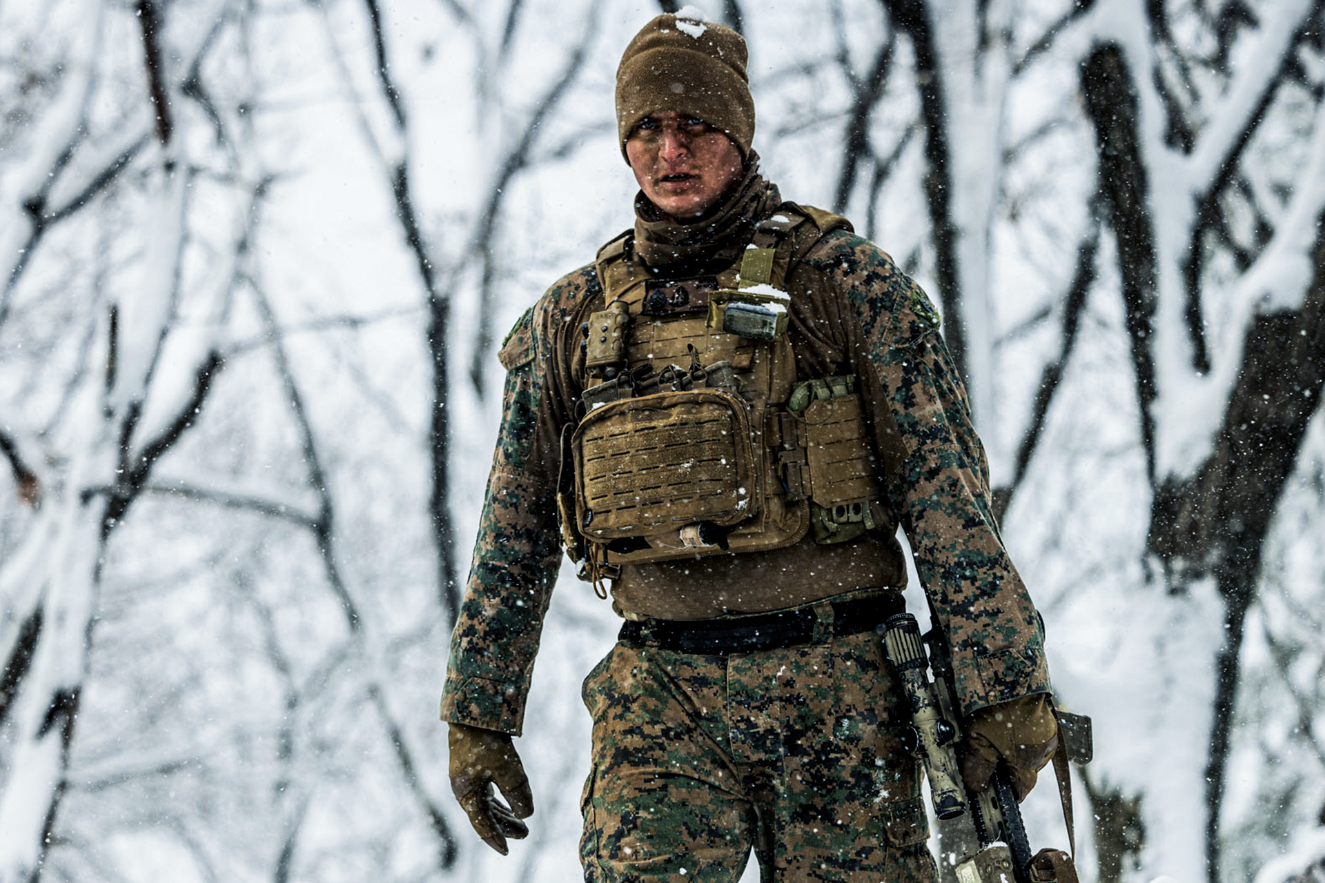 Marine wears tactical vest with pouches and cold weather gear during winter training exercise in South Korea.