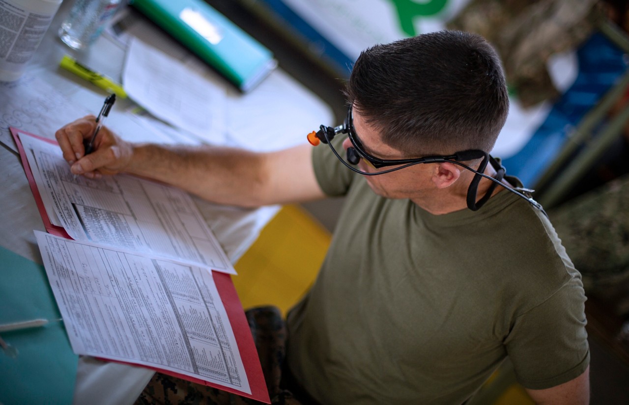 Marine filling out paperwork.