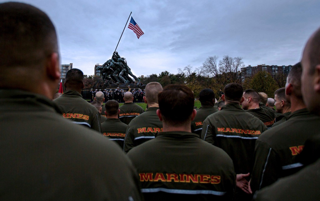 Marines sitting in front of the Marine Corps war memorial.