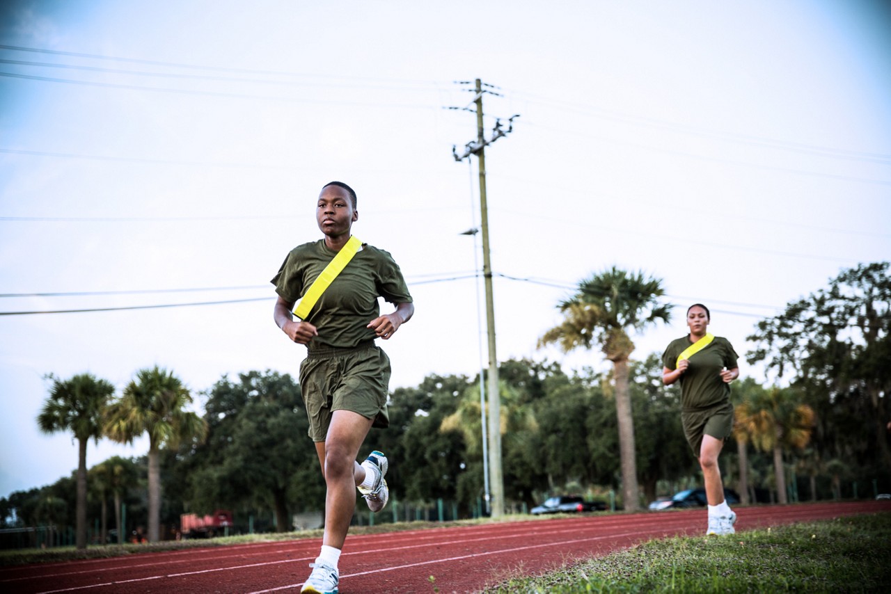 Two aspiring Marines running around track.