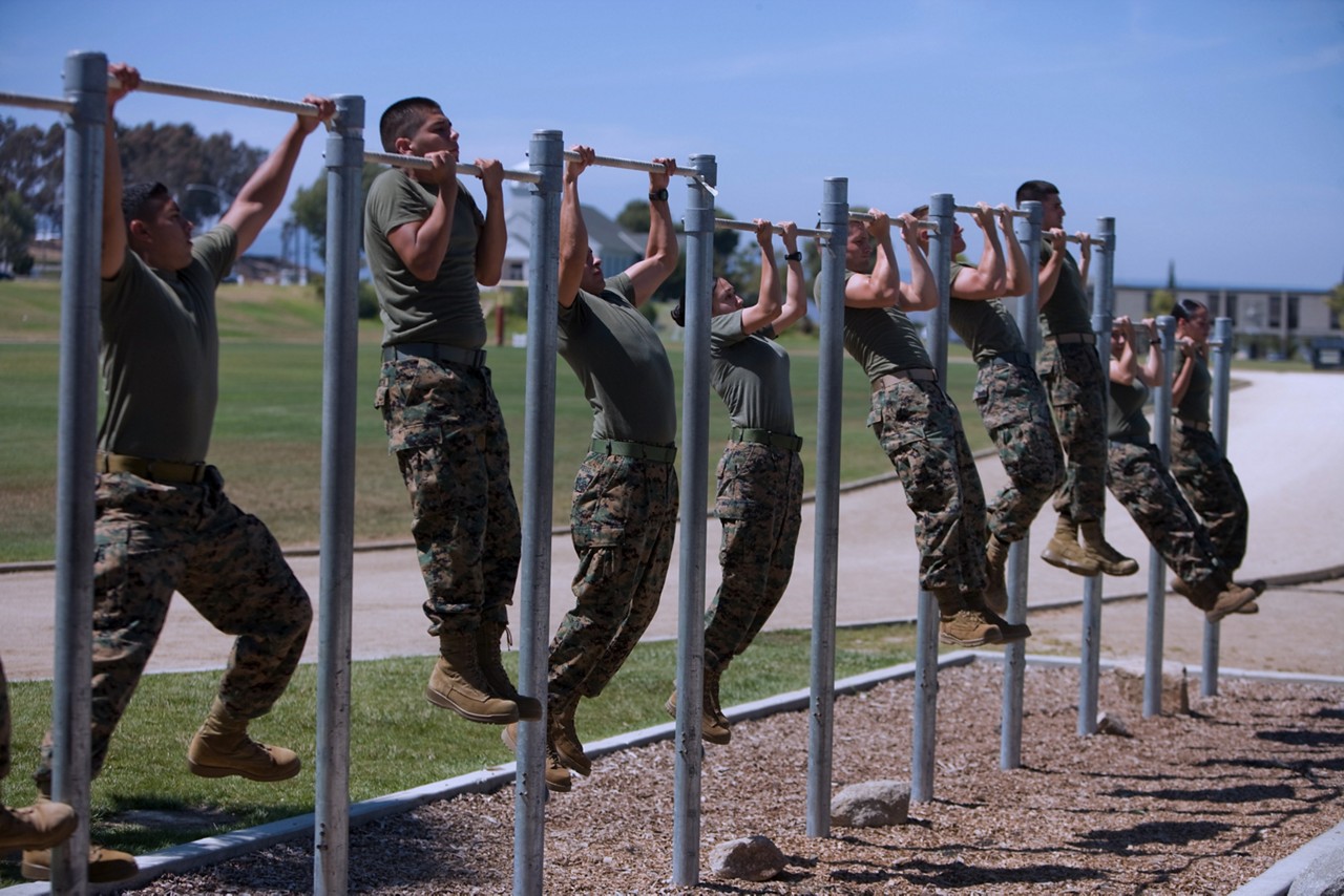 Aspiring Marine doing pull ups to showcase physical fitness.