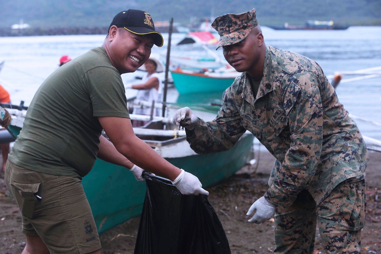 Marines picking up trash while performing community service.